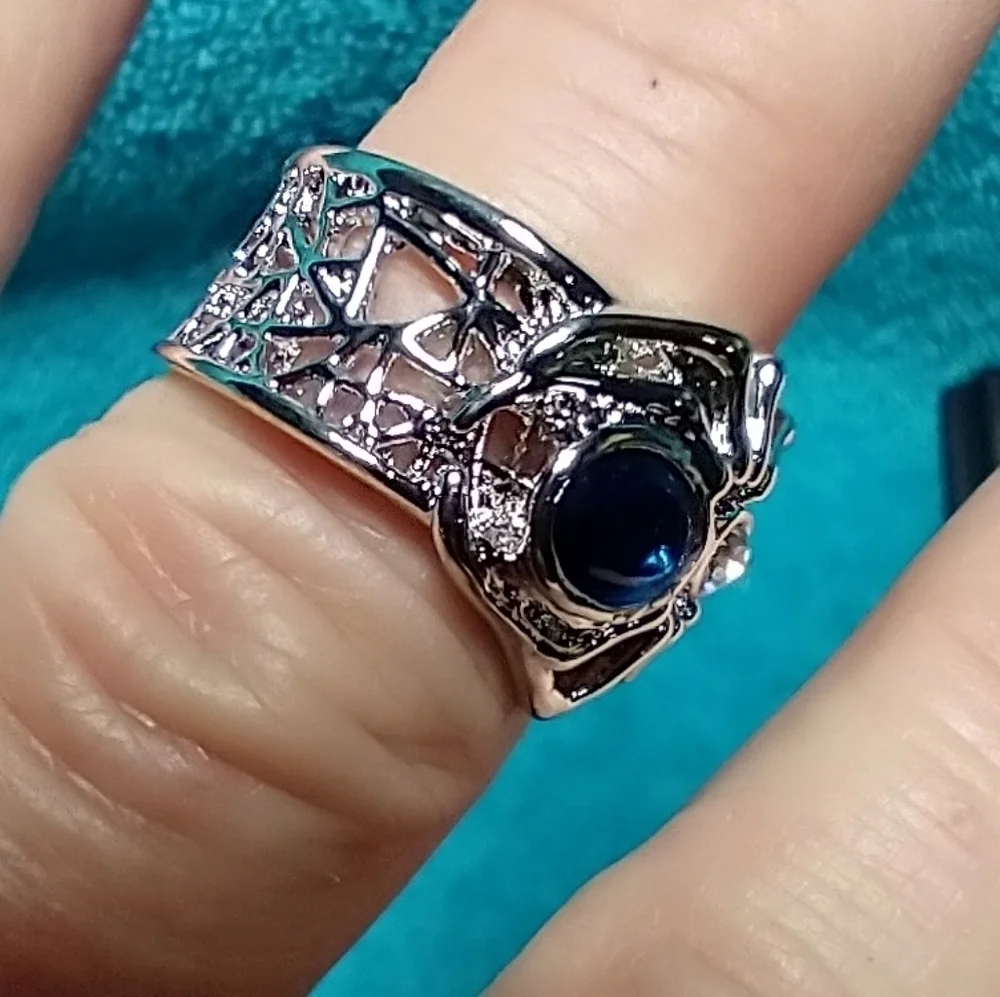 Silvertone spider web ring blue stone